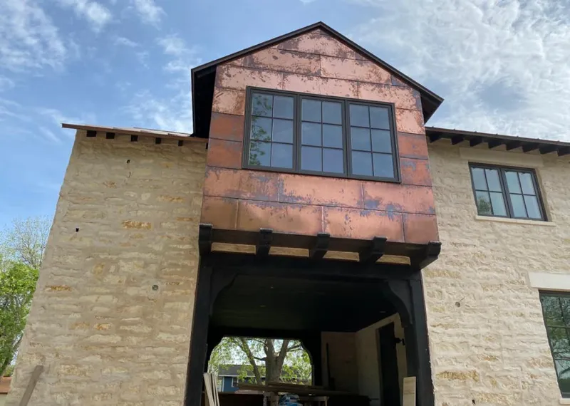 Copper metal panel facade on a stone building for Skylight Installation in Asheboro